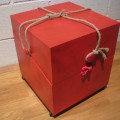 This red crate has a utilitarian feature, a rope that becomes a pull. (14" x 13.5" x 15.5")