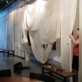 Ashley works on the curtain.